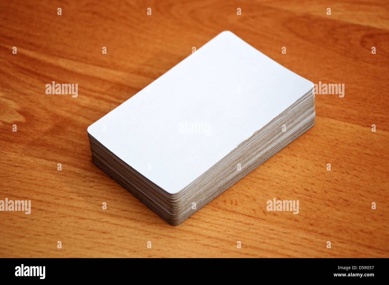 Stapel von Visitenkarten mit abgerundeten Ecken über einem hölzernen Hintergrund Stockfoto