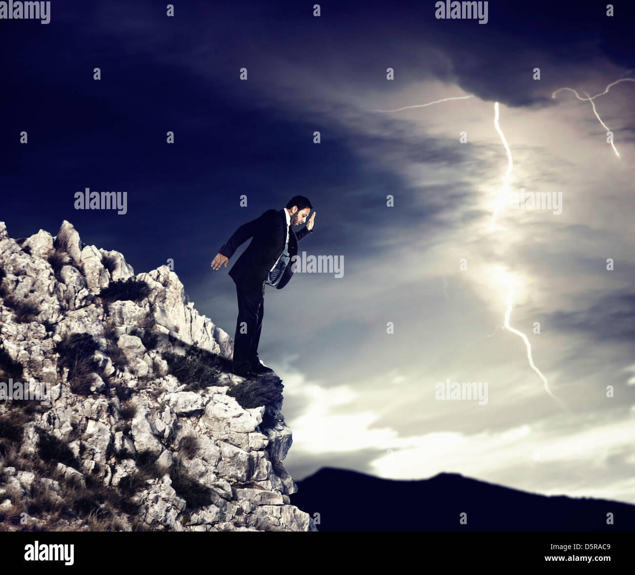 Geschäftsmann am Abgrund mit Sturm Stockfoto