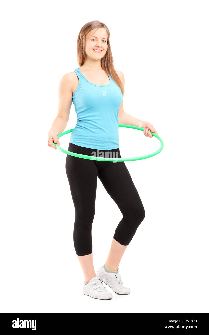 Voller Länge Porträt einer jungen Frau das Training mit einem Hula-hoop isoliert auf weißem Hintergrund Stockfoto