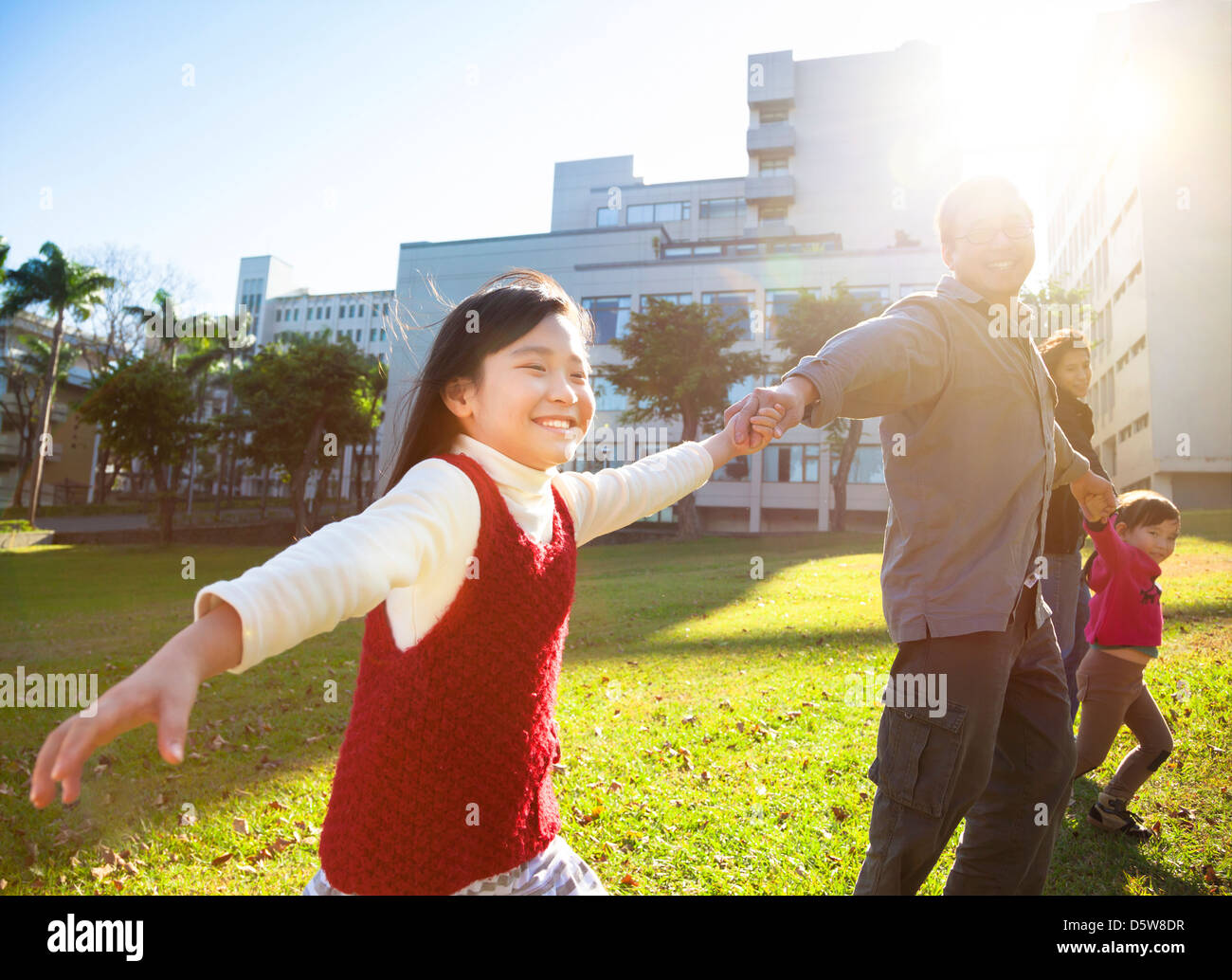 glückliche kleine Mädchen mit der Familie im park Stockfoto