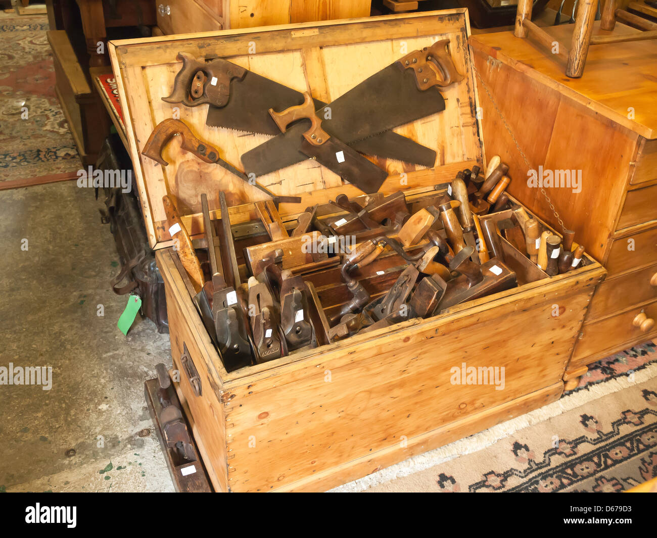 Eine große Schachtel mit herkömmlichen Holzbearbeitungswerkzeugen in einem ländlichen Antiquitätengeschäft. Stockfoto