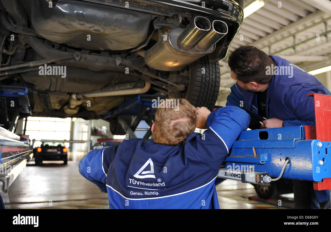 (Fiel) - stellt ein Datei-Bild vom 4. Mai 2010 zeigt einen TÜV Rheinland Mitarbeiter überprüfen ein Auto für die Sicherheit in Neuss, Deutschland. Die EU-Kommission will ältere Autos durch Deutschland technische Inspektion Association (TÜV) jährlich statt alle zwei Jahre überprüft werden, da die Practic Ein Deutschland ist. Foto: Achim Scheidemann Stockfoto