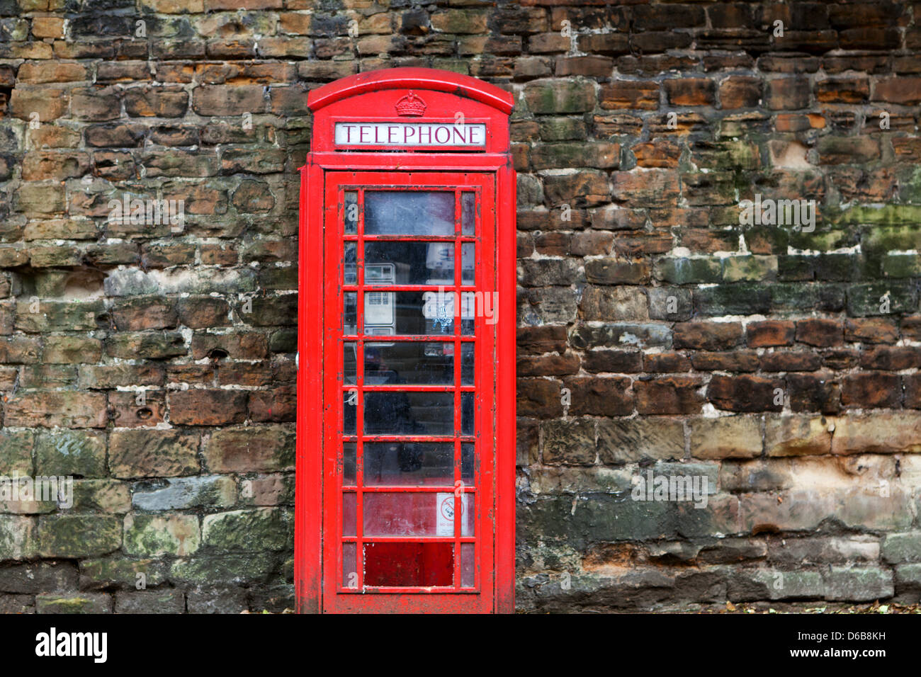 Die britische rote Telefonzelle auf alten Mauer Stockfoto