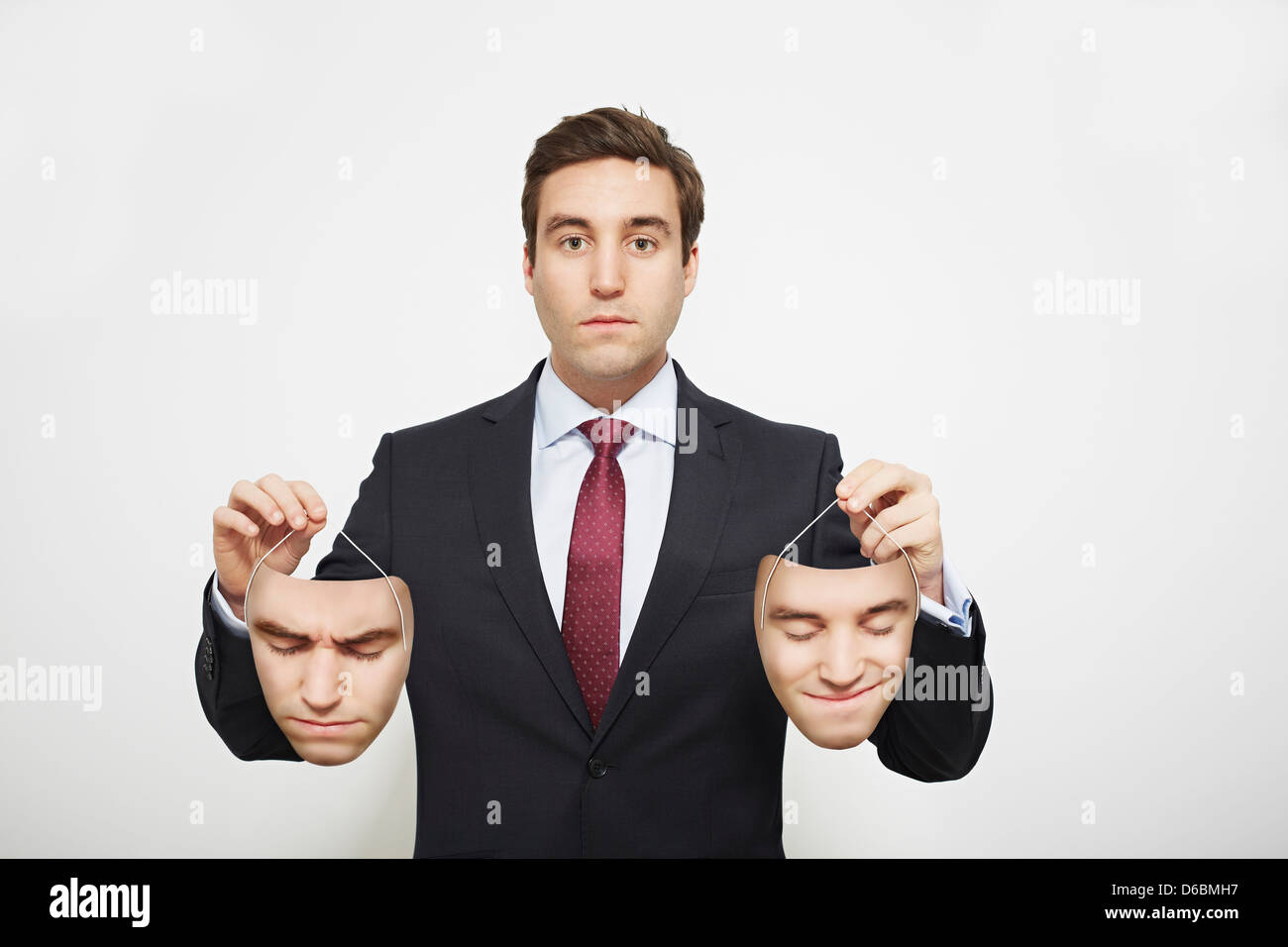 Geschäftsmann Holding Masken Stockfoto