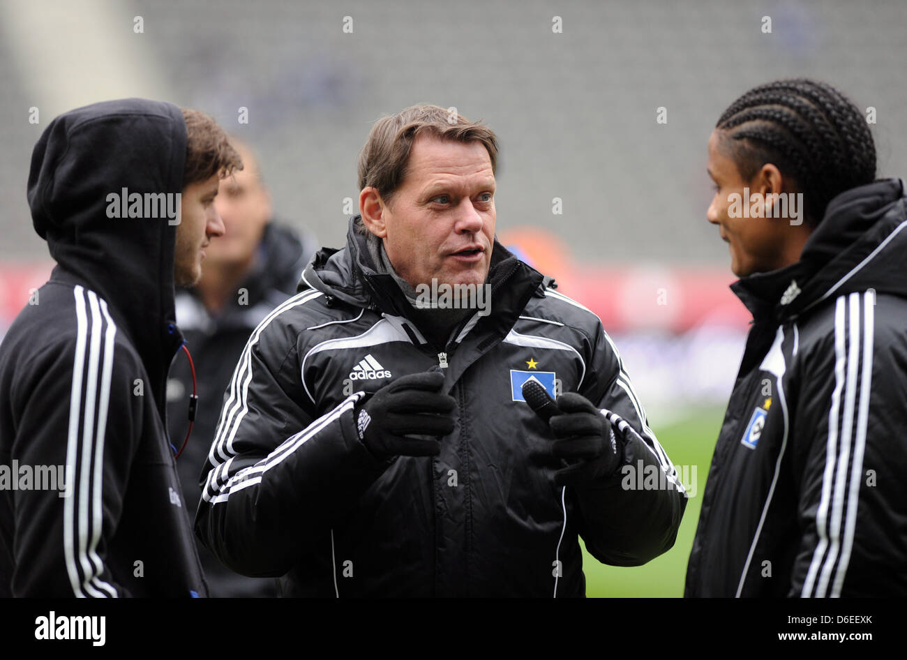 Frank Arnesen (C), Sportdirektor beim Hamburger SV, Gespräche, Spieler Michael Mancienne (R) und Jacopo Sala vor Anpfiff der Bundesliga Hertha BSC gegen den Hamburger SV am Olympiastadion in Berlin, Deutschland, 28. Januar 2012 entsprechen. Foto: Soeren Stache Stockfoto
