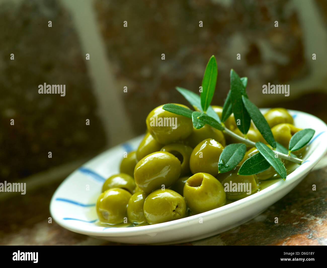 Grüne Oliven und Olive leaf Stockfoto