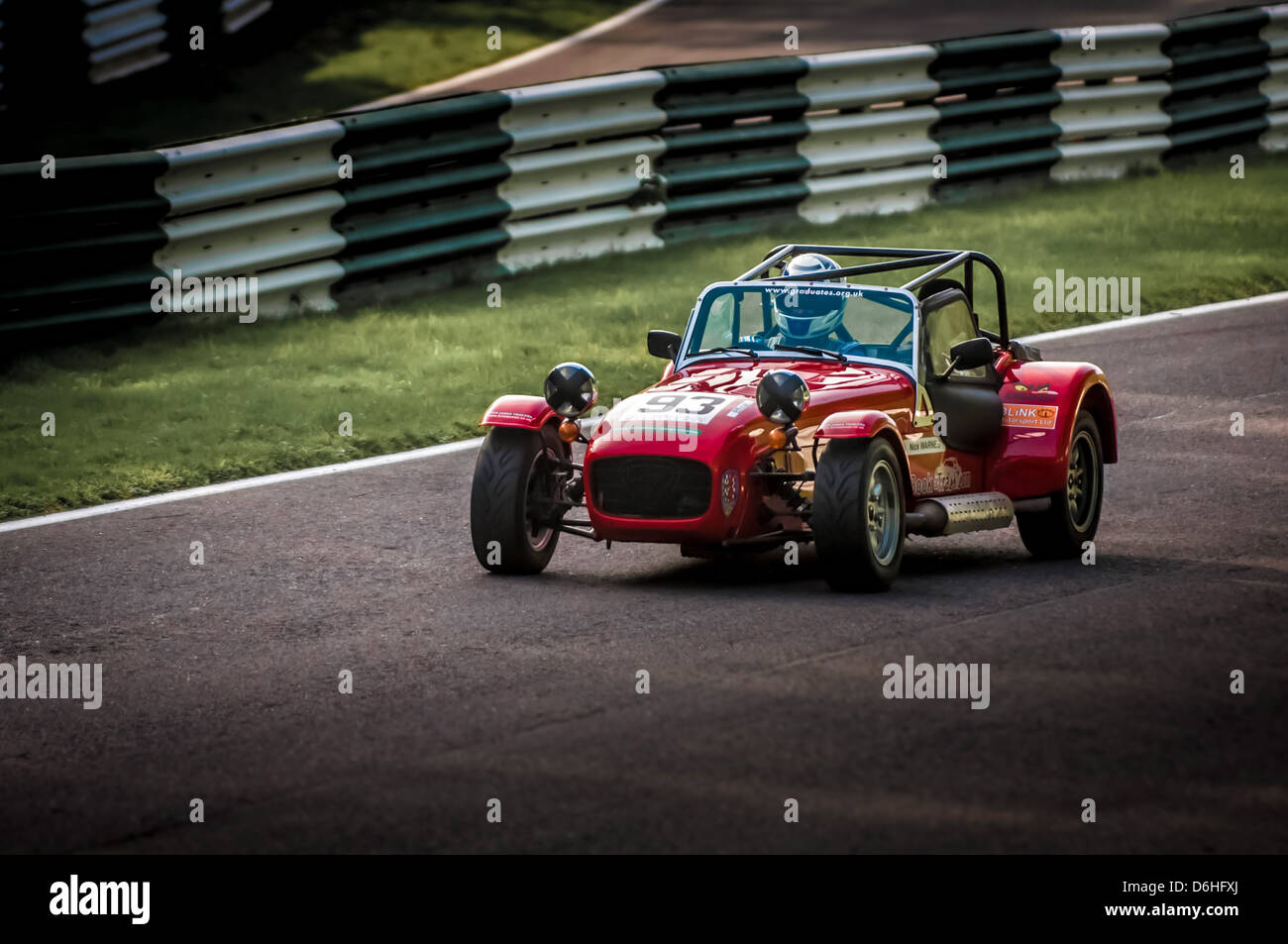 Red Caterham Seven Sportwagen auf der Rennstrecke Cadwell Park. Stockfoto