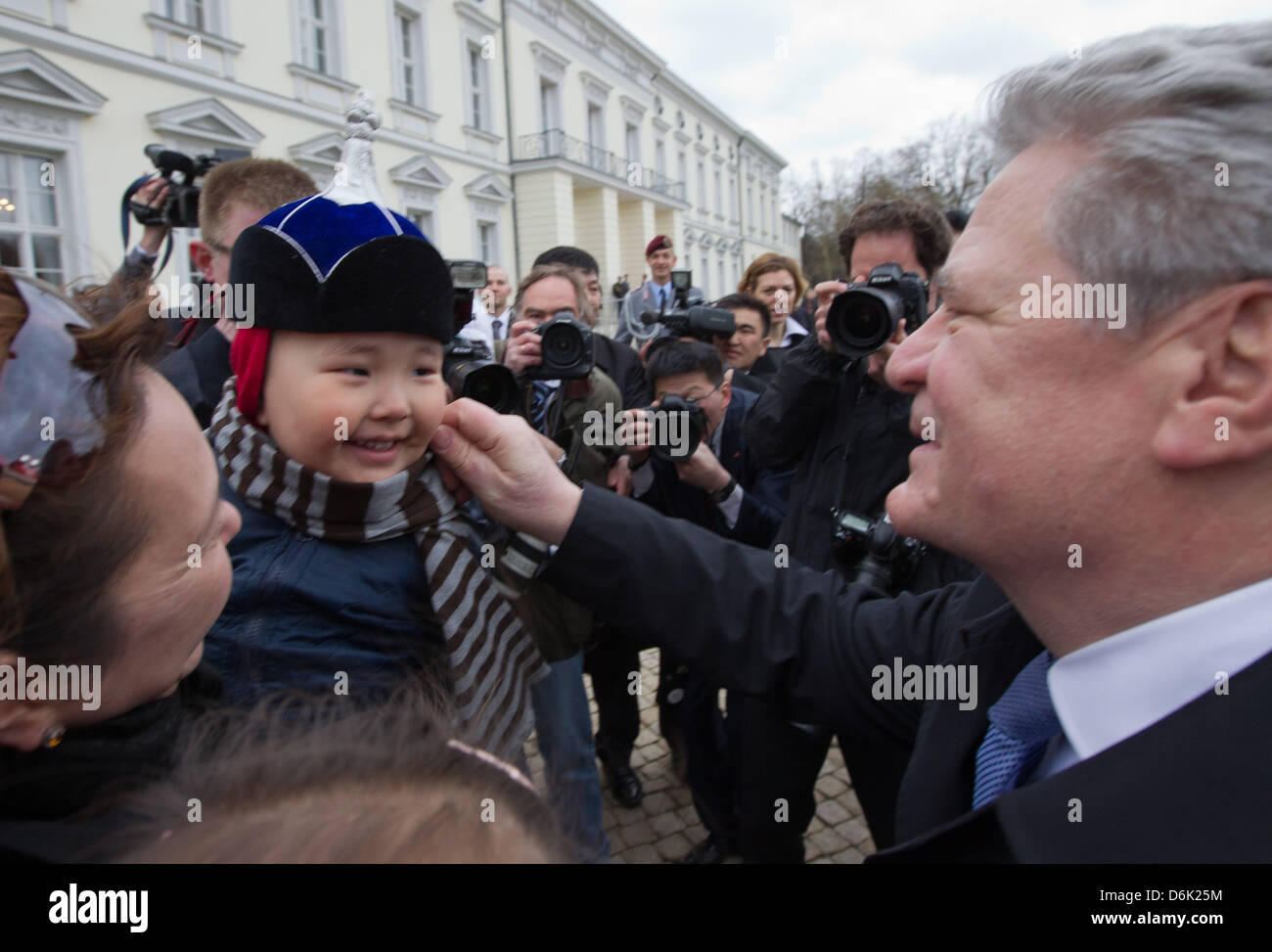 German President Joachim Gauck (R) klopft ein Kind eine Besuchergruppe beim Staatsempfang für den mongolischen Präsidenten vor Schloss Bellevue in Berlin, Deutschland, 29. März 2012. Der mongolische Präsident ist zurzeit zum Staatsbesuch nach Deutschland. Foto: Michael Kappeler Stockfoto