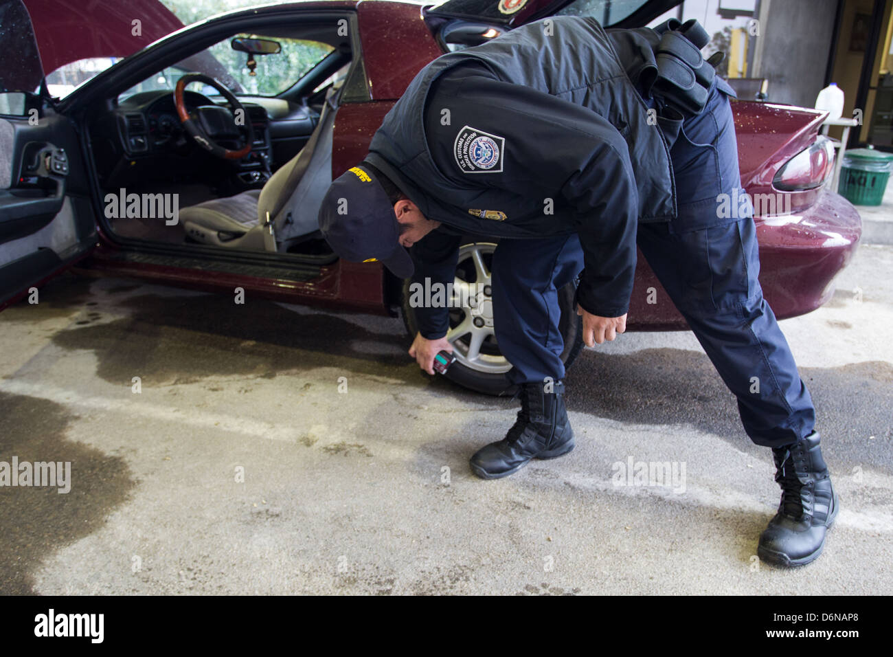Ein US Customs and Border Protection Officer eine Schmuggelware Detektionsgerät, bekannt als ein Buster verwendet, um ein Fahrzeug am Grenzübergang San Luis zu inspizieren 16. Februar 2012 in San Luis, AZ. Stockfoto