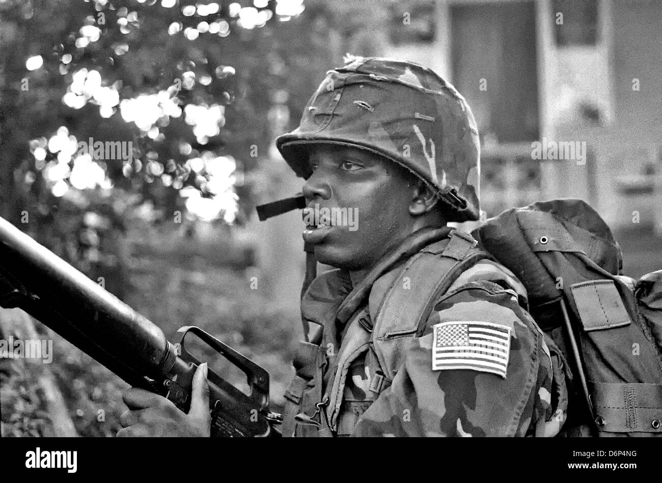 Ein US-Marine bewaffnet mit M16A1 Gewehr Patrouillen die Gegend um Grenville während der Invasion von Grenada, unter dem Codenamen Operation Urgent Fury 25. Oktober 1983 in Grenville, Grenada. Die Invasion begann am 25. Oktober 1983 und wurde die erste größere militärische Aktion von den Vereinigten Staaten seit dem Ende des Vietnam-Krieges. Stockfoto