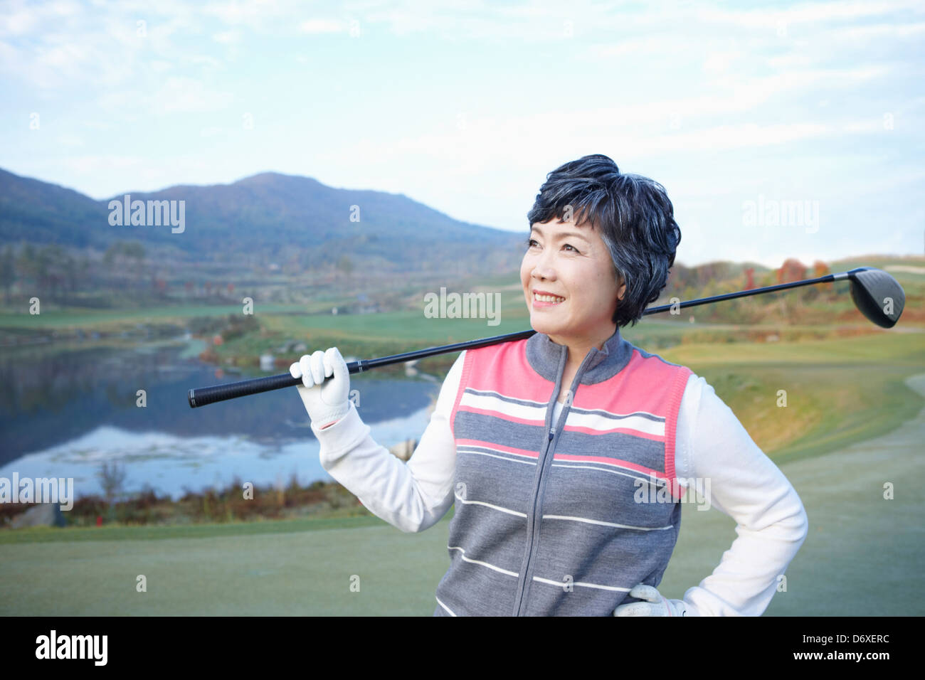 eine Frau mit einem Golf-Club auf einem Golfplatz Stockfoto