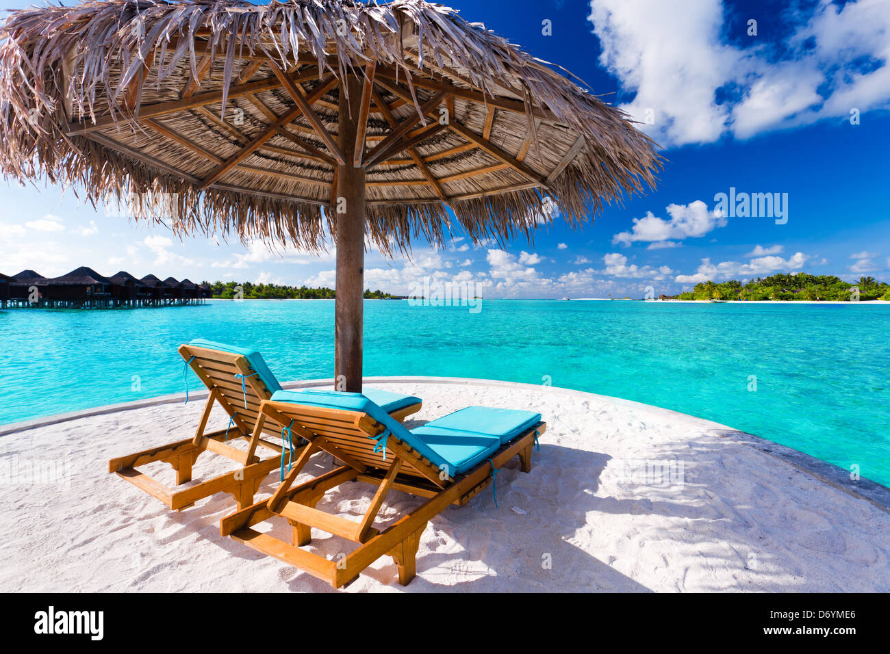 Zwei Stühle und Sonnenschirm am atemberaubenden tropischen Strand Stockfoto