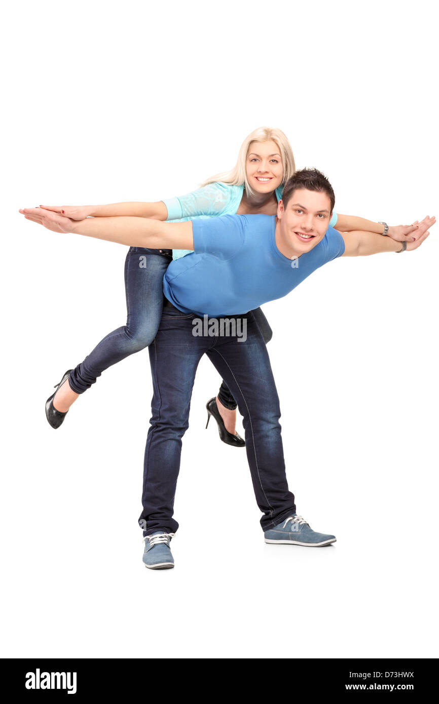 In voller Länge Portrait von ein glückliches junges Paar posing Huckepack isoliert auf weißem Hintergrund Stockfoto