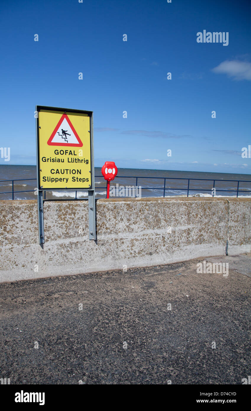 Zweisprachige Welsh / englische Schilder an der Promenade in Prestatyn "Gofal / Vorsicht" Stockfoto