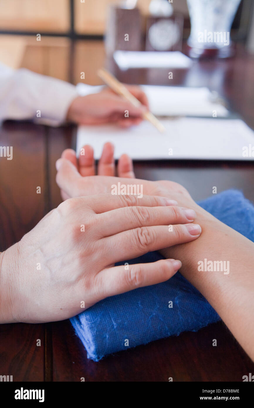 Nahaufnahme der Hand des Patienten, während Doktor Puls nimmt Stockfoto