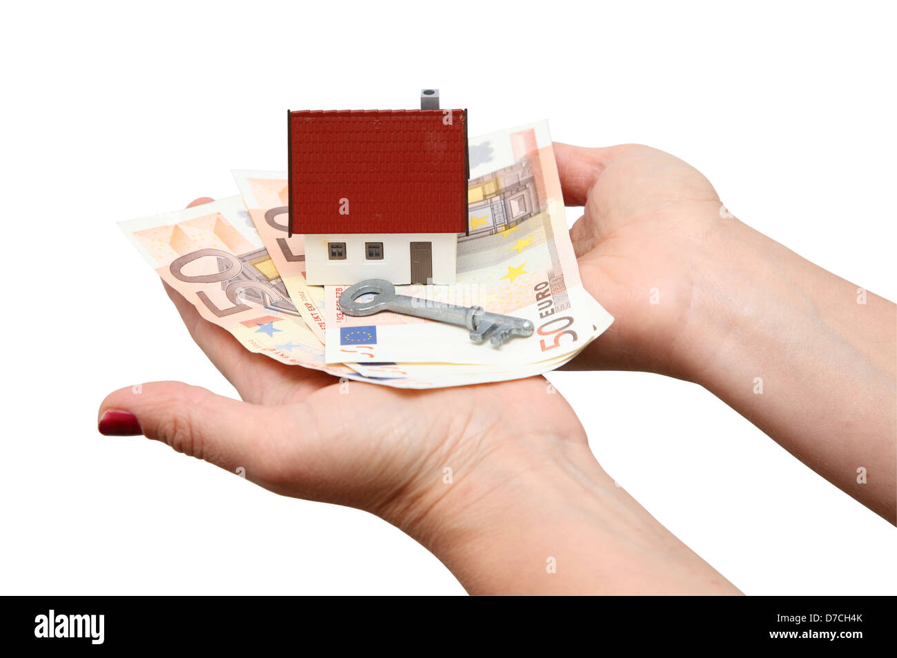 Haus mit Geld und Schlüssel isoliert auf weiß Stockfoto