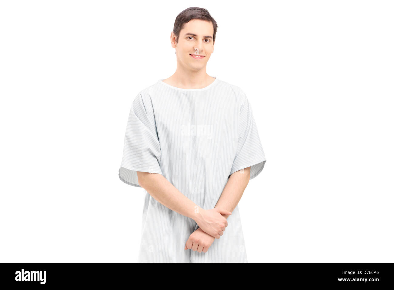 Ein männlicher Patient in einem Krankenhauskleid, isoliert auf weißem Hintergrund Stockfoto