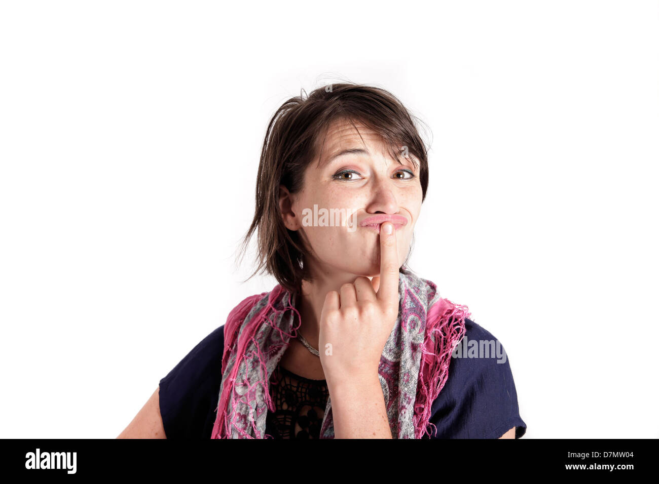 Junge Frau mit der Hand unter ihr Gesicht isoliert im Studio mit Blick Stockfoto
