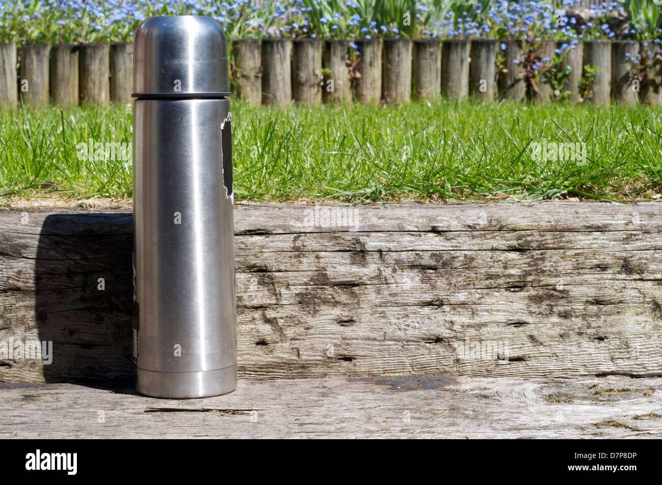 Thermoskanne im Garten bereit für Pause Stockfoto