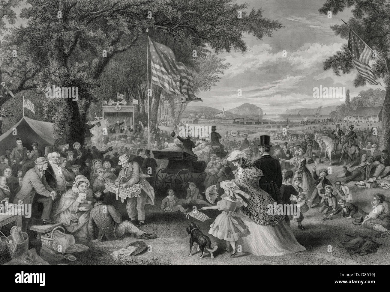 "Der Tag wir feiern" 1876 eine große Versammlung von Menschen picknicken, spielen und genießen die Independence Day Feier im Freien unter großen Bäumen und offenen Rasen, mit Fernblick über eine Eisenbahn Zug vorbei und von Schiffen auf einer Wasserstraße in den Hintergrund. Stockfoto