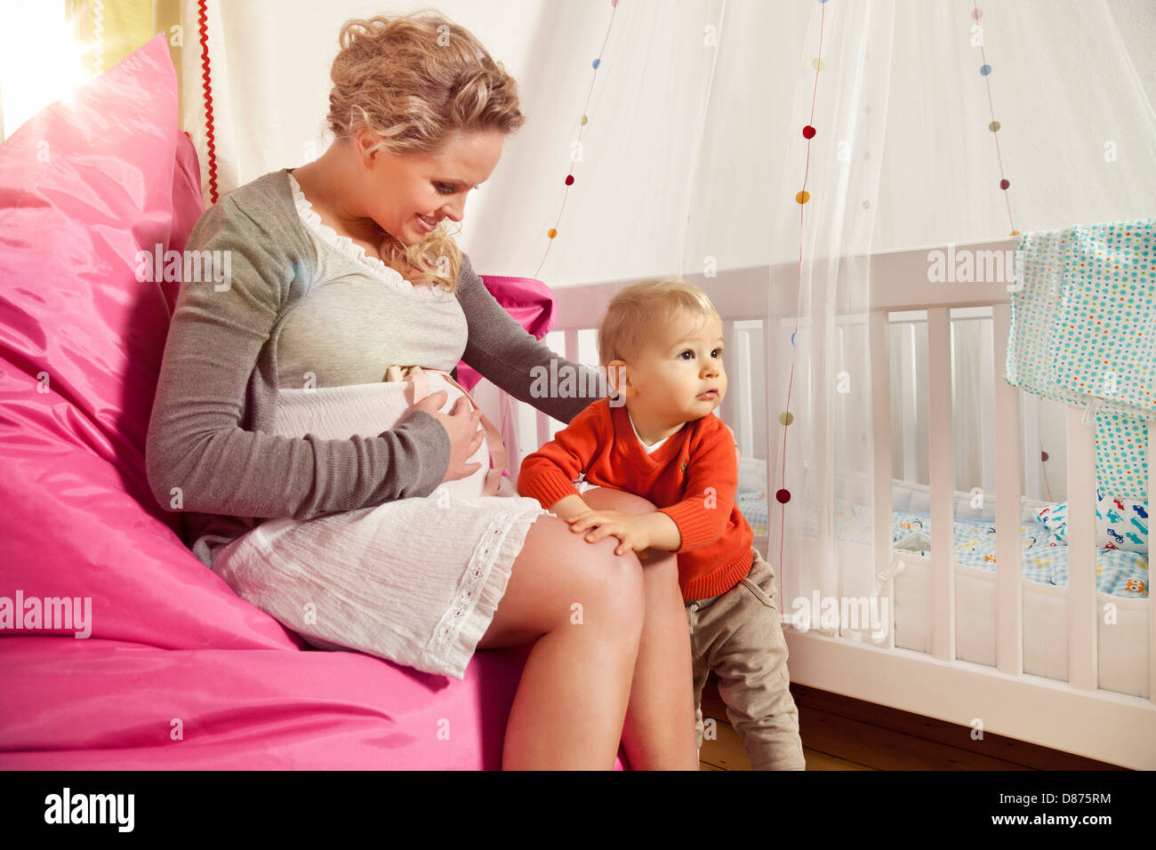 Deutschland, Bonn, schwangere Mutter, Sohn, lächelnd zu erklären, ihr Bauch Stockfoto