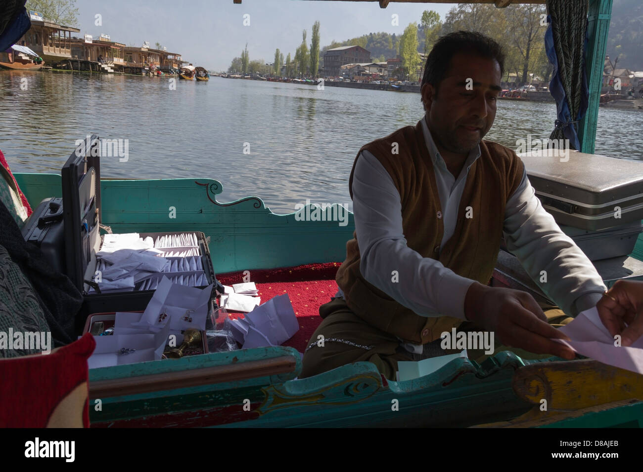 Kashmiri Mann verkaufen künstliche Schmuck aus einem anderen Shikara im Dal-See, wir werden auf einer Shikara und er auf einem anderen Stockfoto