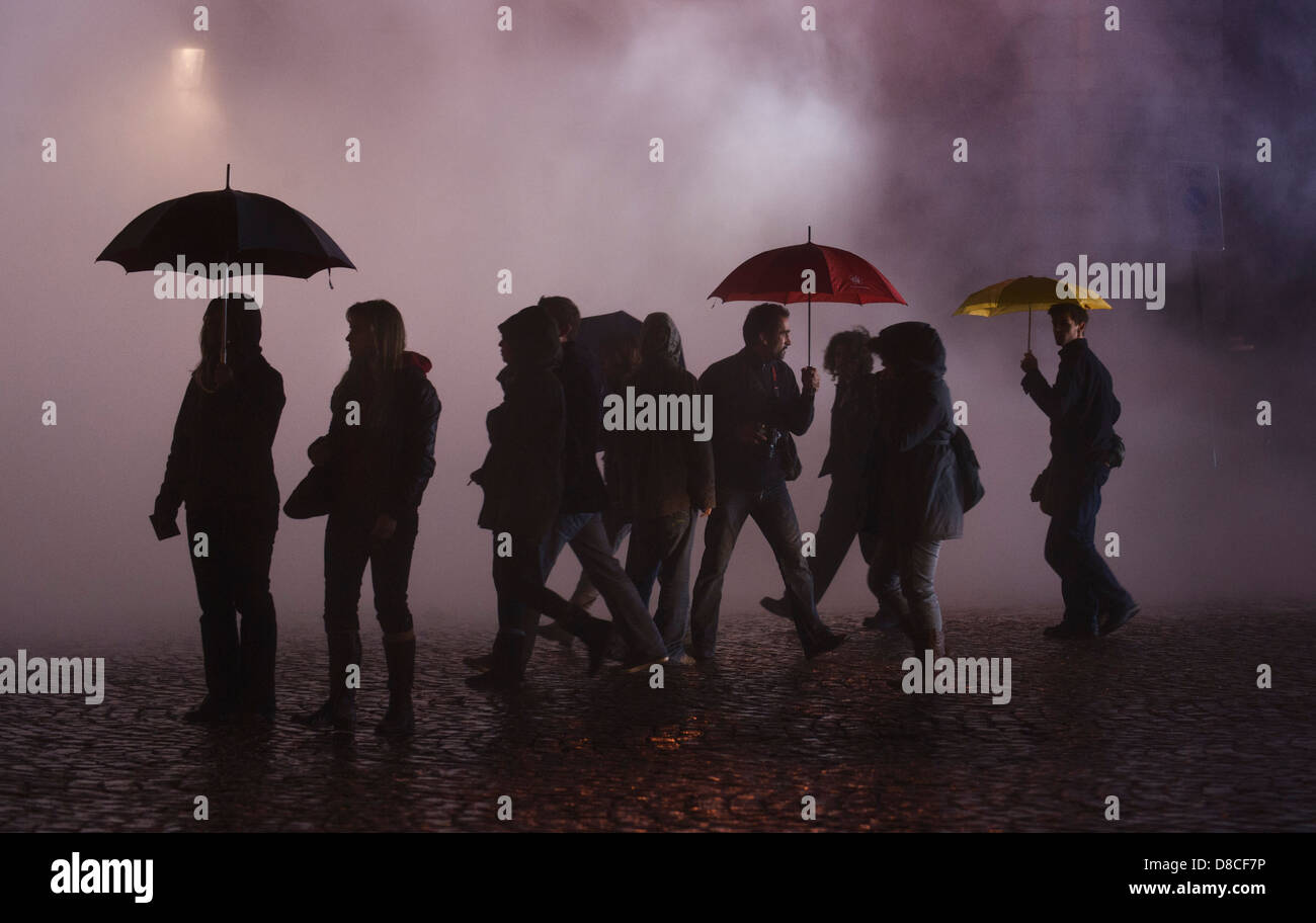 Menschen mit Regenschirmen gehen über den Nebel in der Nacht in Brüssel, Belgien, 3. Oktober 2009. (Adrien Veczan) Stockfoto