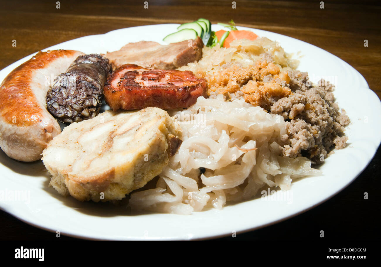 typisches Essen Slowenien Blutwurst gebraten-Wurst getrocknet-Schweinekoteletts Buchweizen-Brei sauren Rüben Kohl Brot Knödel Platte tr Stockfoto