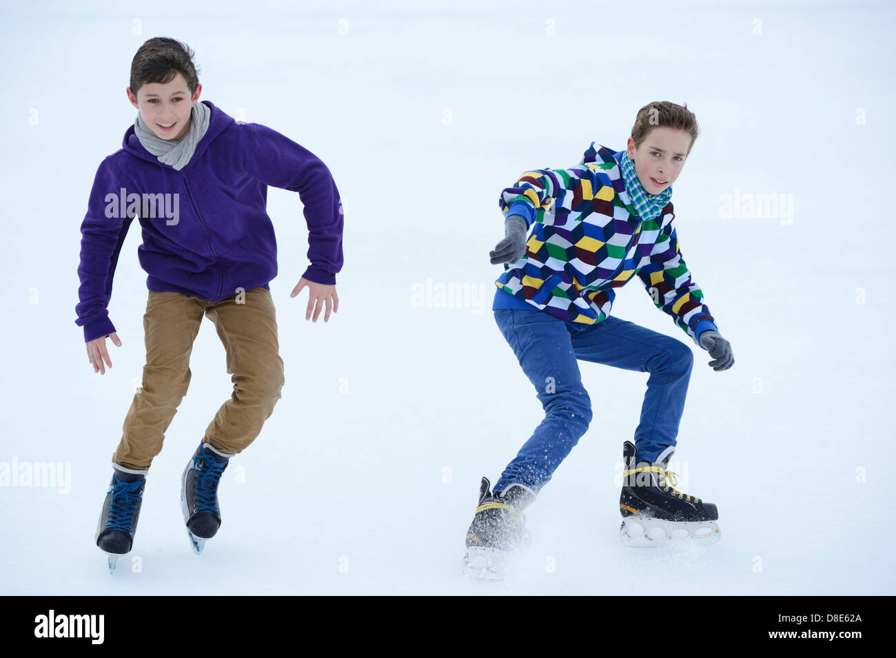 Zwei jungen auf einem gefrorenen See Schlittschuh laufen Stockfoto
