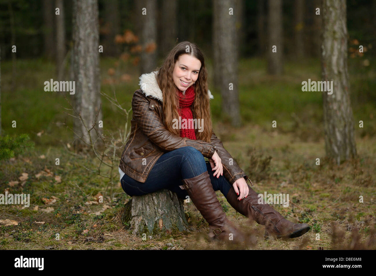 Lächelnde junge Frau im Wald Stockfoto