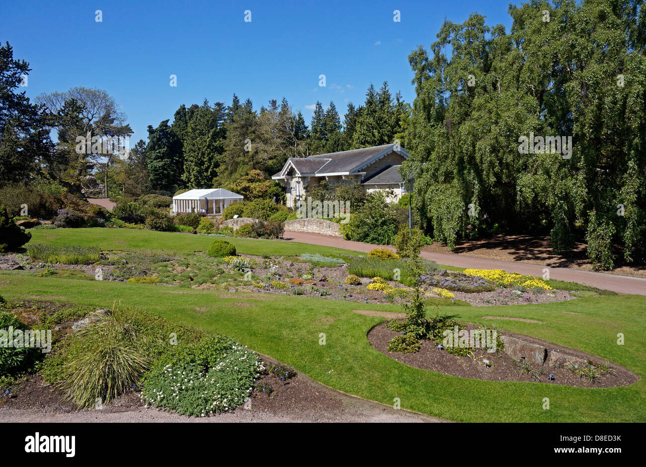 Der Steingarten und Stream Bereich mit Caledonian Hall des Royal Botanic Garden in Edinburgh, Schottland Stockfoto