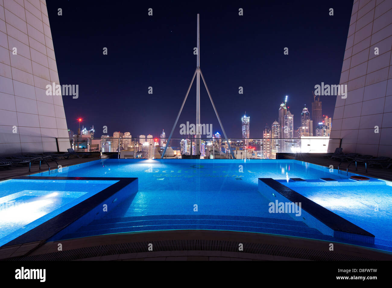 Pool auf dem Dach eines Wolkenkratzers in Jumeirah Lakes Towers (JLT) in der Nacht mit Blick auf Skyline, New Dubai, Vereinigte Arabische Emirate Stockfoto