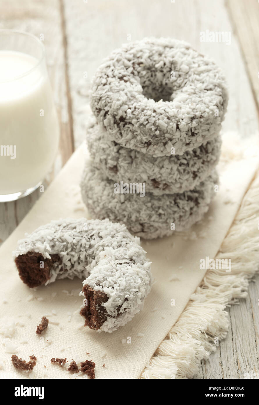 Schließen Sie herauf Bild der frisch zubereitete Schokolade Donuts bedeckt mit Kokosflocken Stockfoto