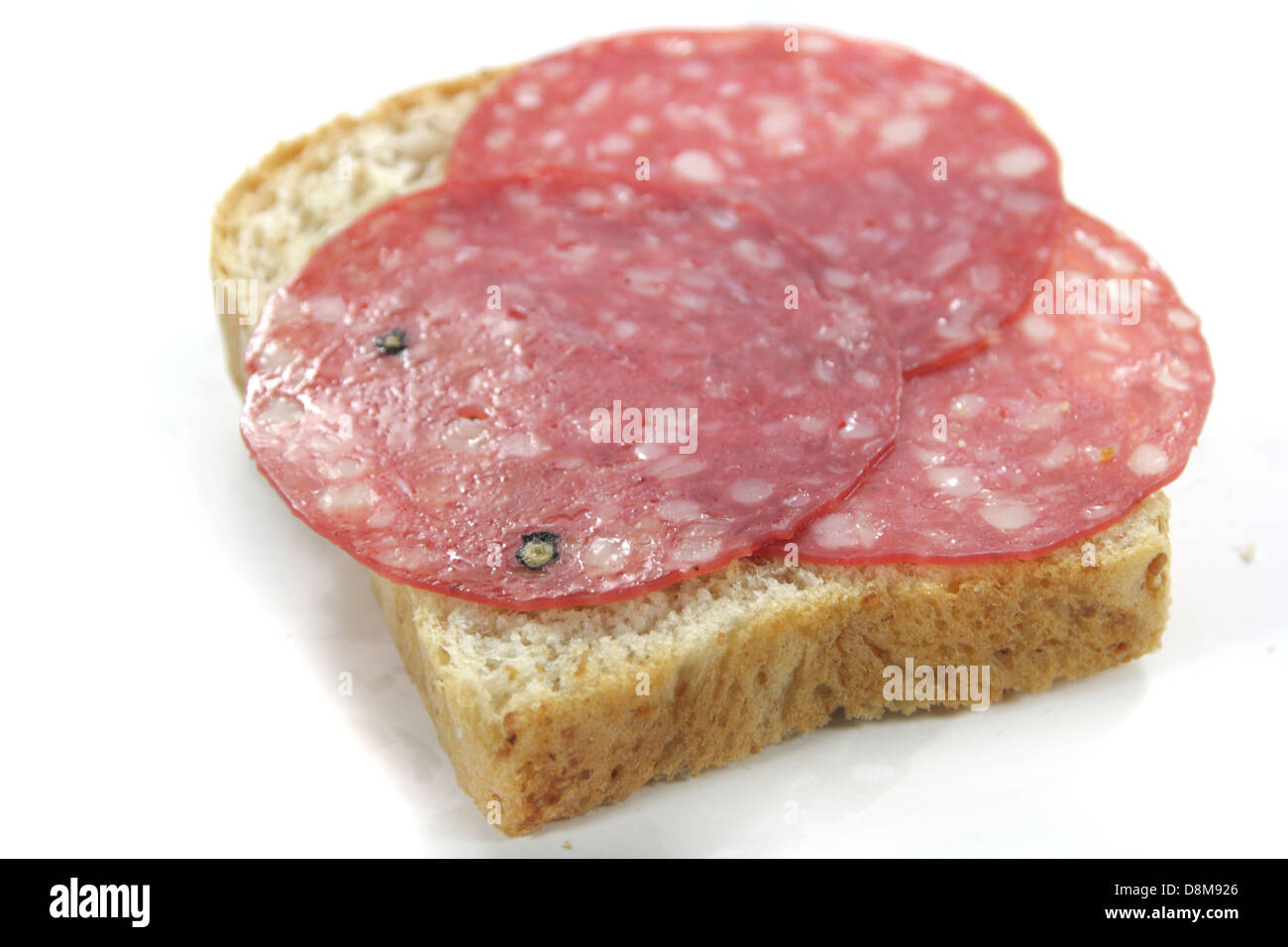 Geschnittene Salami auf Vollkornbrot Stockfoto