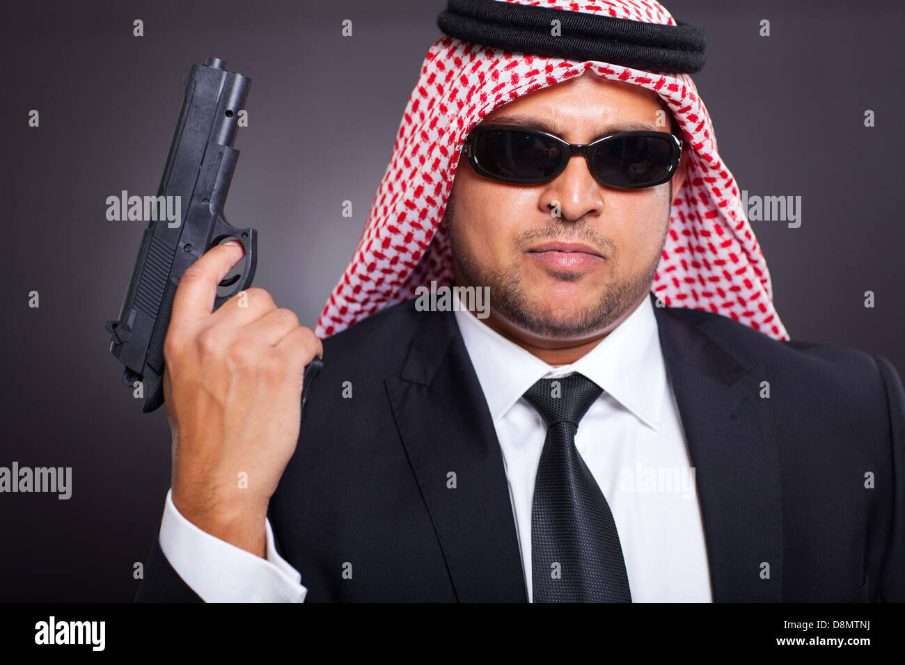 Arabische schlagen Mann mit Pistole auf schwarzem Hintergrund Stockfoto