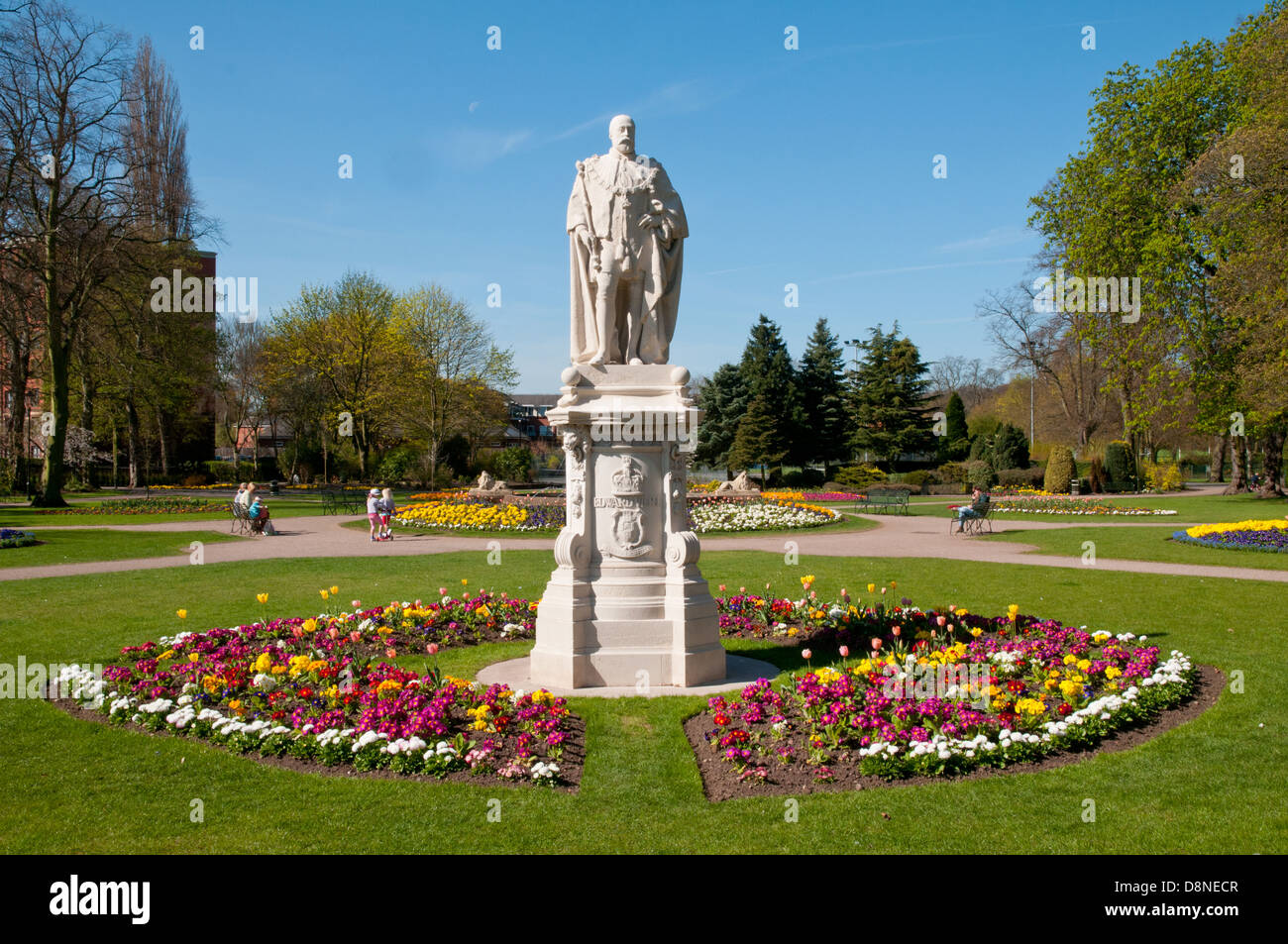 Statue von Edward VII. Art Siebter mit Frühlingsblumen in Beacon Park Gardens Lichfield Staffordshire England Stockfoto