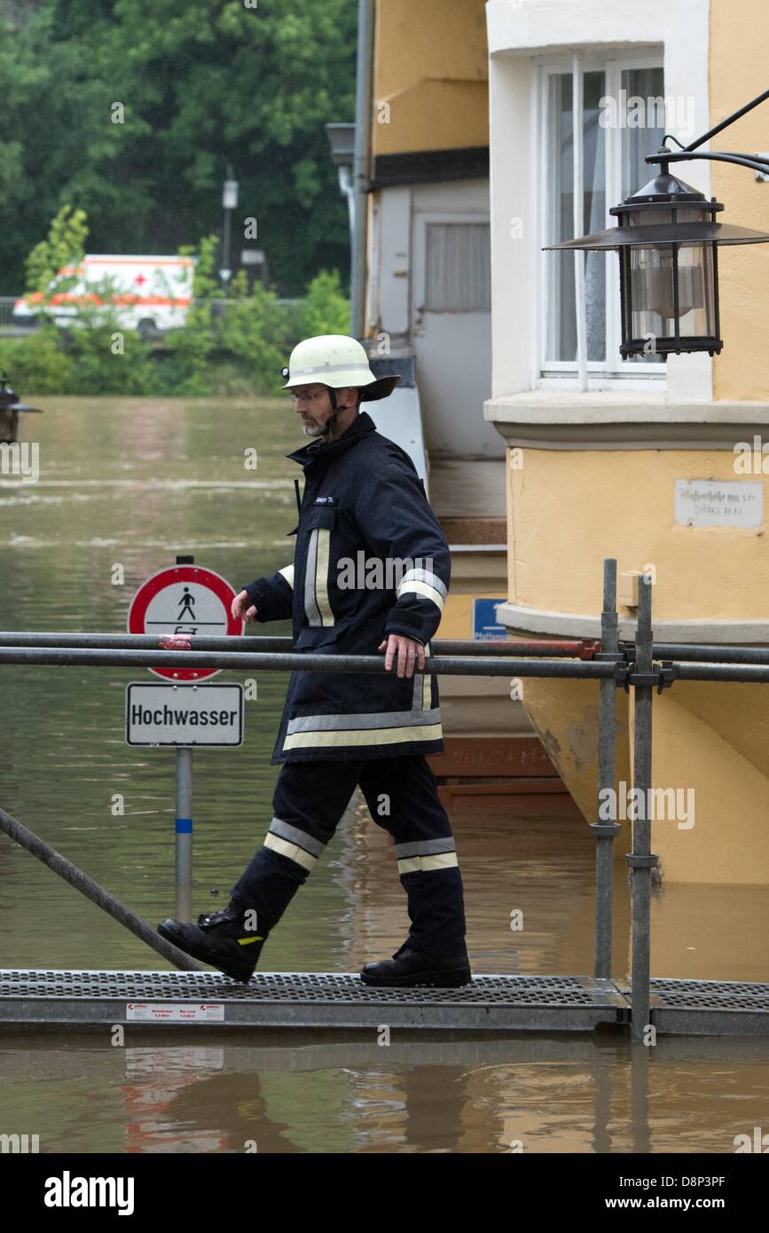 Passau, Deutschland. 2. Juni 2013. Feuerwehrmann geht über eine Brücke in einer Straße überflutet von Donau in Passau, Deutschland, 2. Juni 2013 installiert. Extreme Regenfälle verursachen viele Überschwemmungen in der Gegend. FOTO: ARMIN WEIGEL Stockfoto