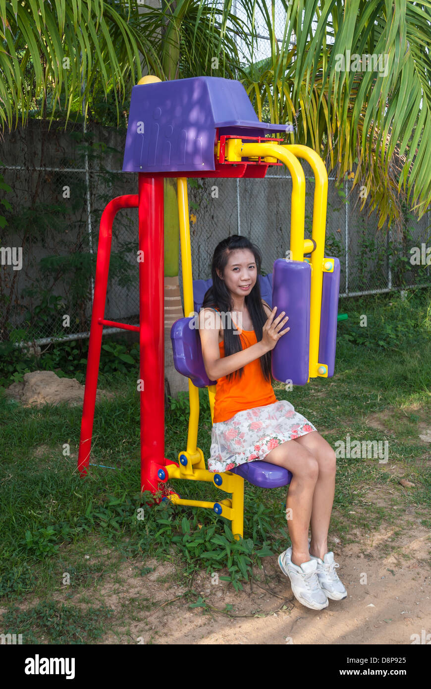 Thai Asiatin mit Heimtrainer im öffentlichen Park. Stockfoto