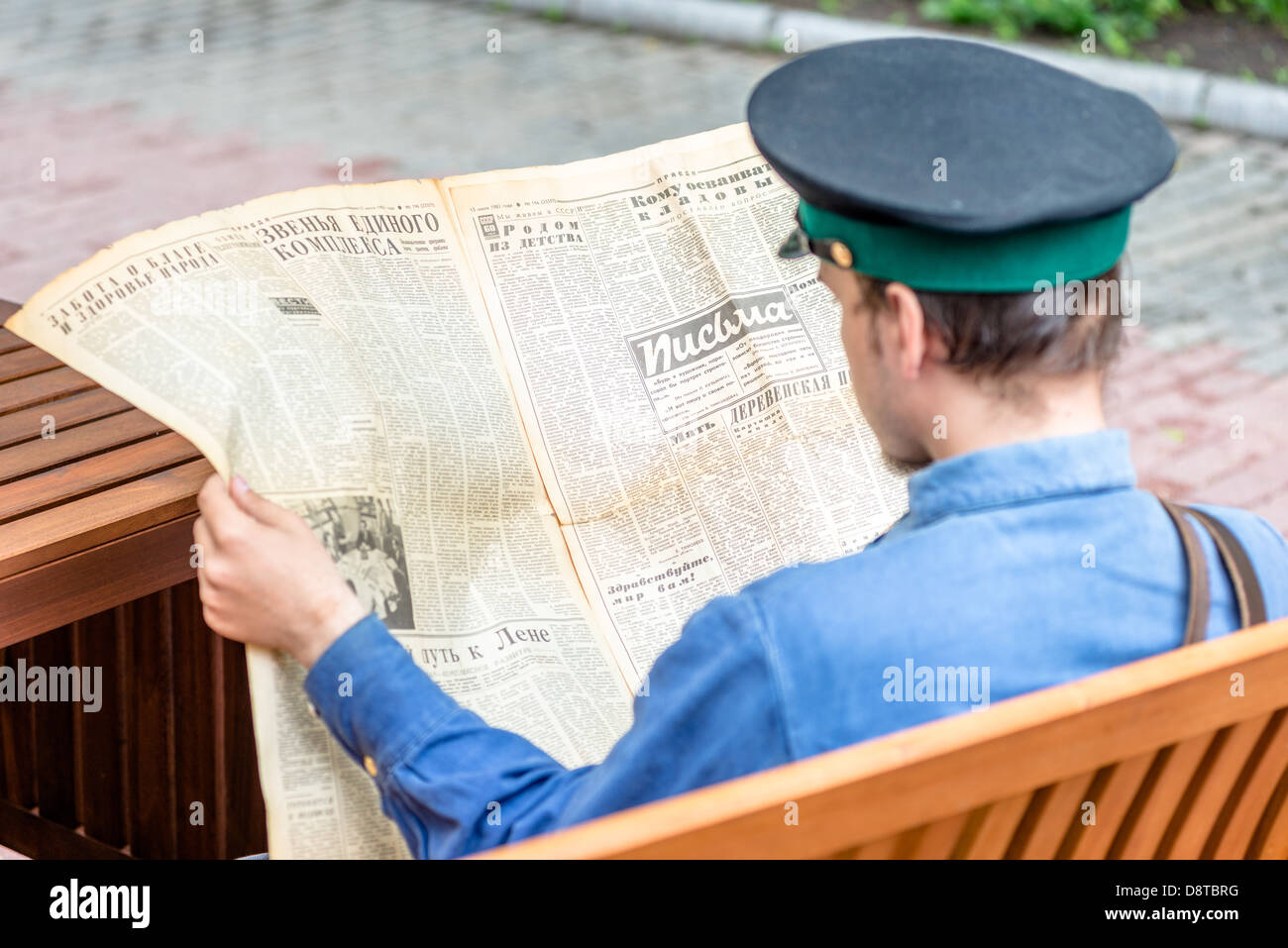 Moskau, Russland - Retro-Festival "Tage der Geschichte" im Eremitage Garten. Mann in Uniform, die sowjetische Zeitung lesen. 26. Mai 2013 Stockfoto