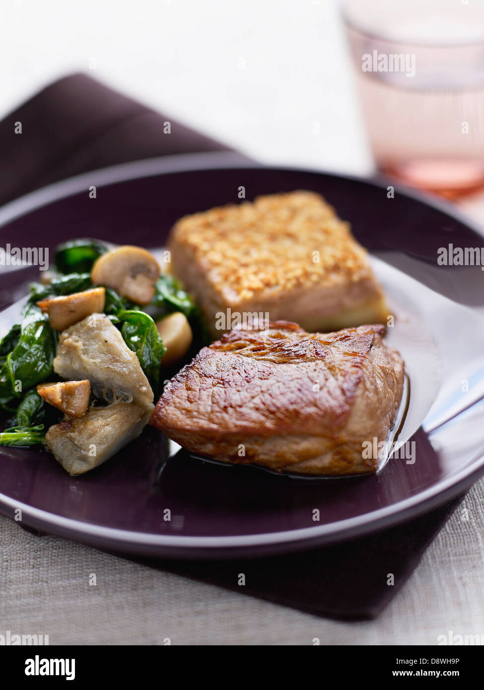 Kalbfleisch-Duo mit gebratenem Spinat, Artischocken und Pilzen Stockfoto