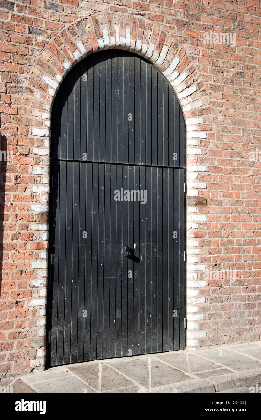 Alte große schwarze Tür für Pferd & Beförderung gewölbt Stockfoto