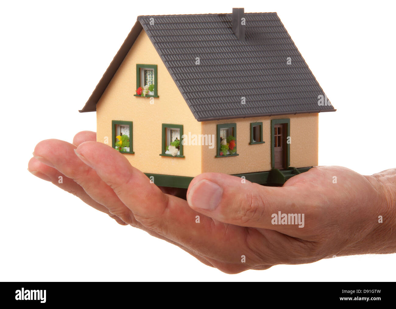 Musterhaus in der Hand über weiß Stockfoto