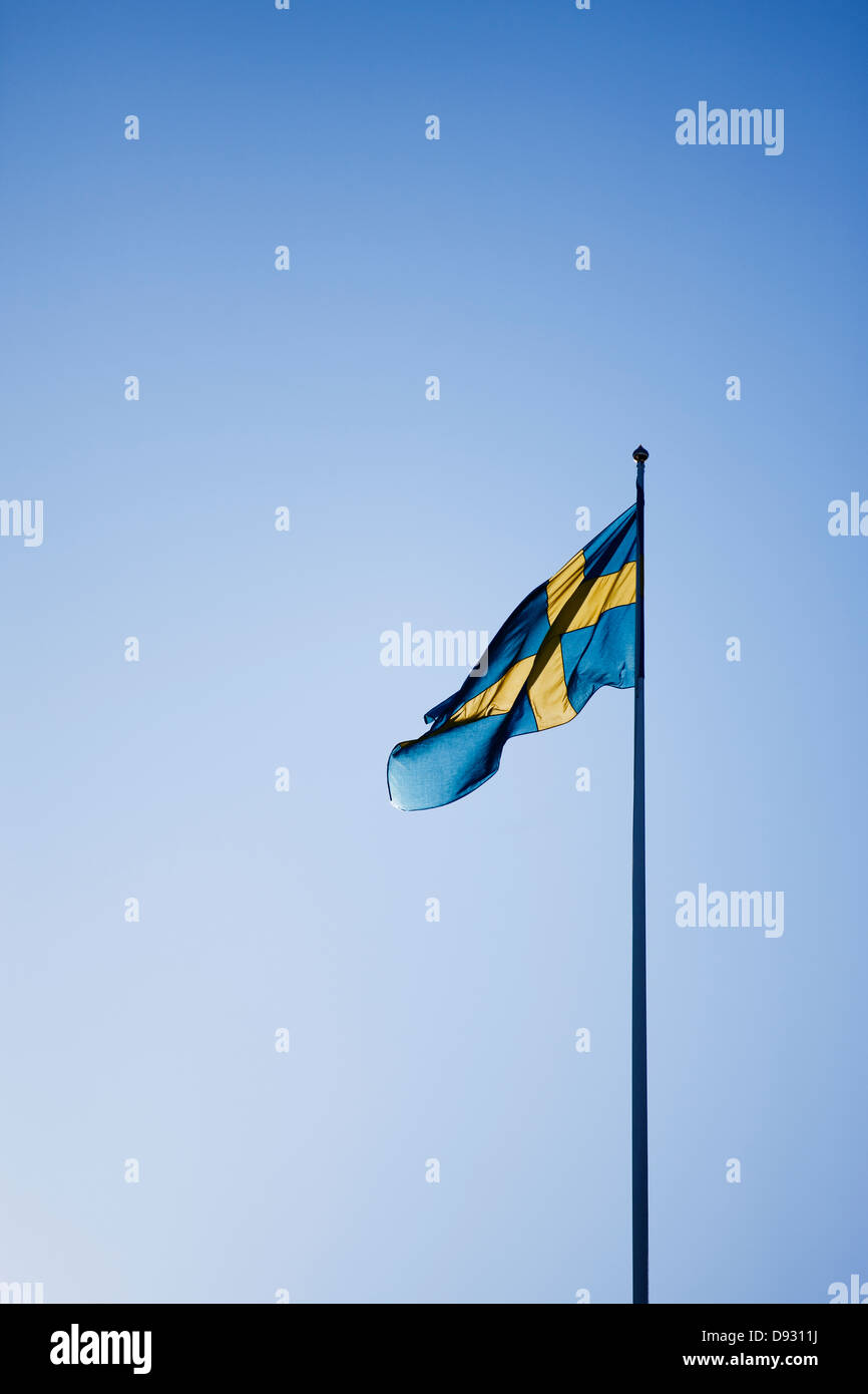 Schwedische Flagge gegen blauen Himmel Stockfoto