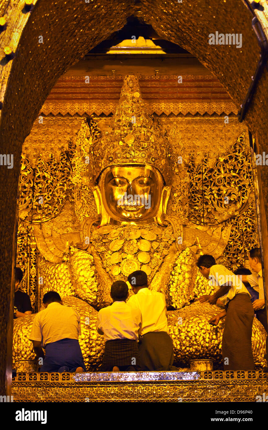 BURMESISCHE Männer vergolden die viel verehrten MAHAMUNI BUDDHI innerhalb der MAHAMUNI PAYA gebaut von König Bodwpaya im Jahre 1784 - MANDALAY, MYANMAR Stockfoto