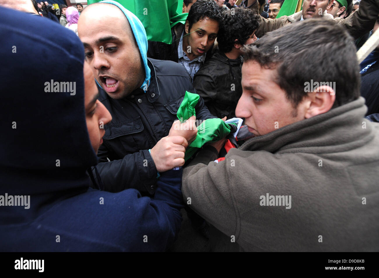 Libysche pro-Gaddafi-Anhänger attackieren gewaltsam eine Gruppe von Demonstranten, die die Flagge der libyschen Rebellen während des Marsches für die Alternative - TUC Demonstration im Zentrum von London. London, England - 26.03.11 Stockfoto