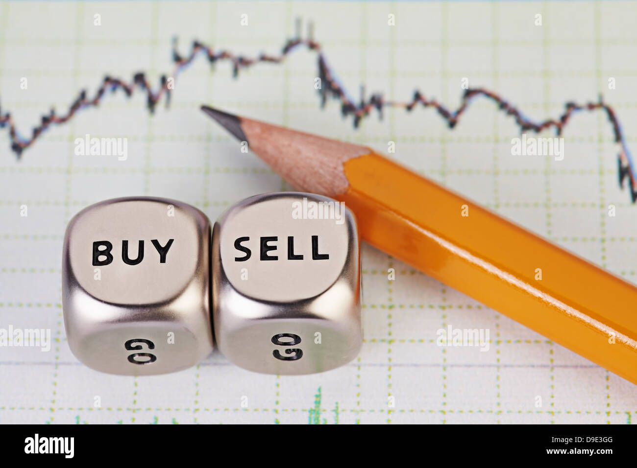 Würfel mit den Worten verkaufen kaufen, Bleistift und finanzielle Diagramm schnetzelt. Selektiven Fokus. Stockfoto