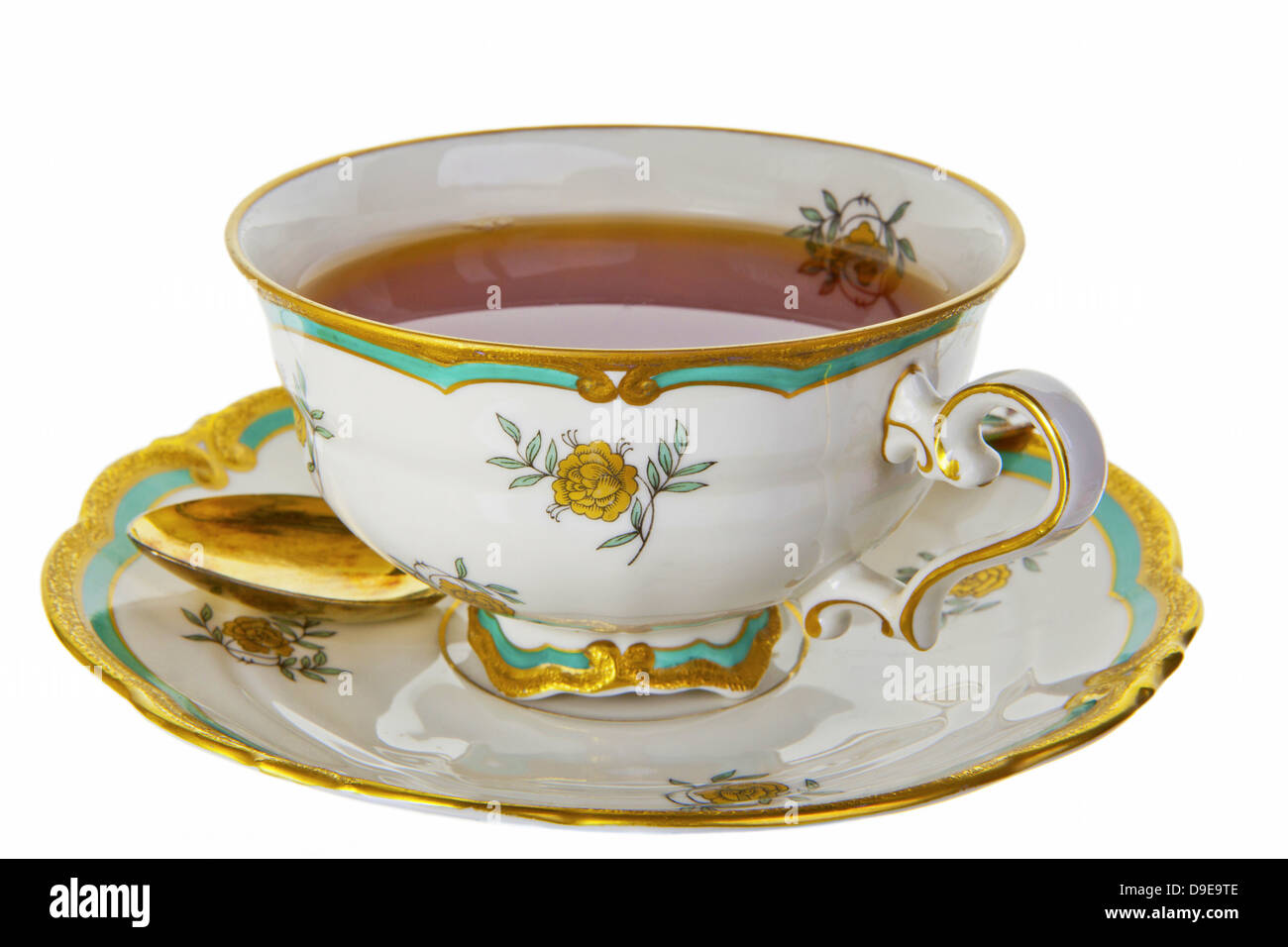 Tee in einer zarten antike Tasse mit Untertasse und Gold Tee-Löffel. Stockfoto