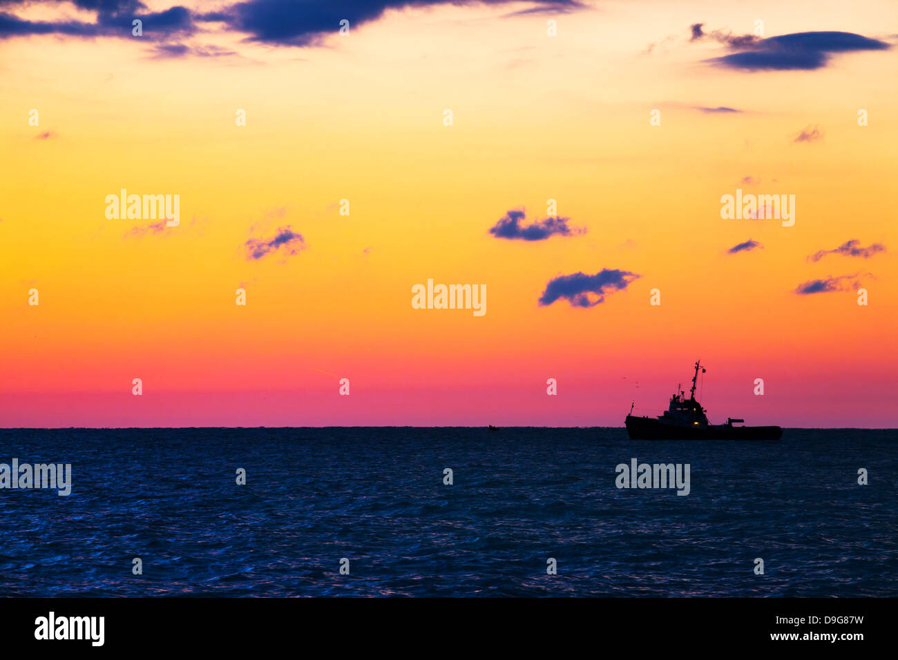 Schiff Fischen auf dem Meer mit Sonnenuntergang Stockfoto