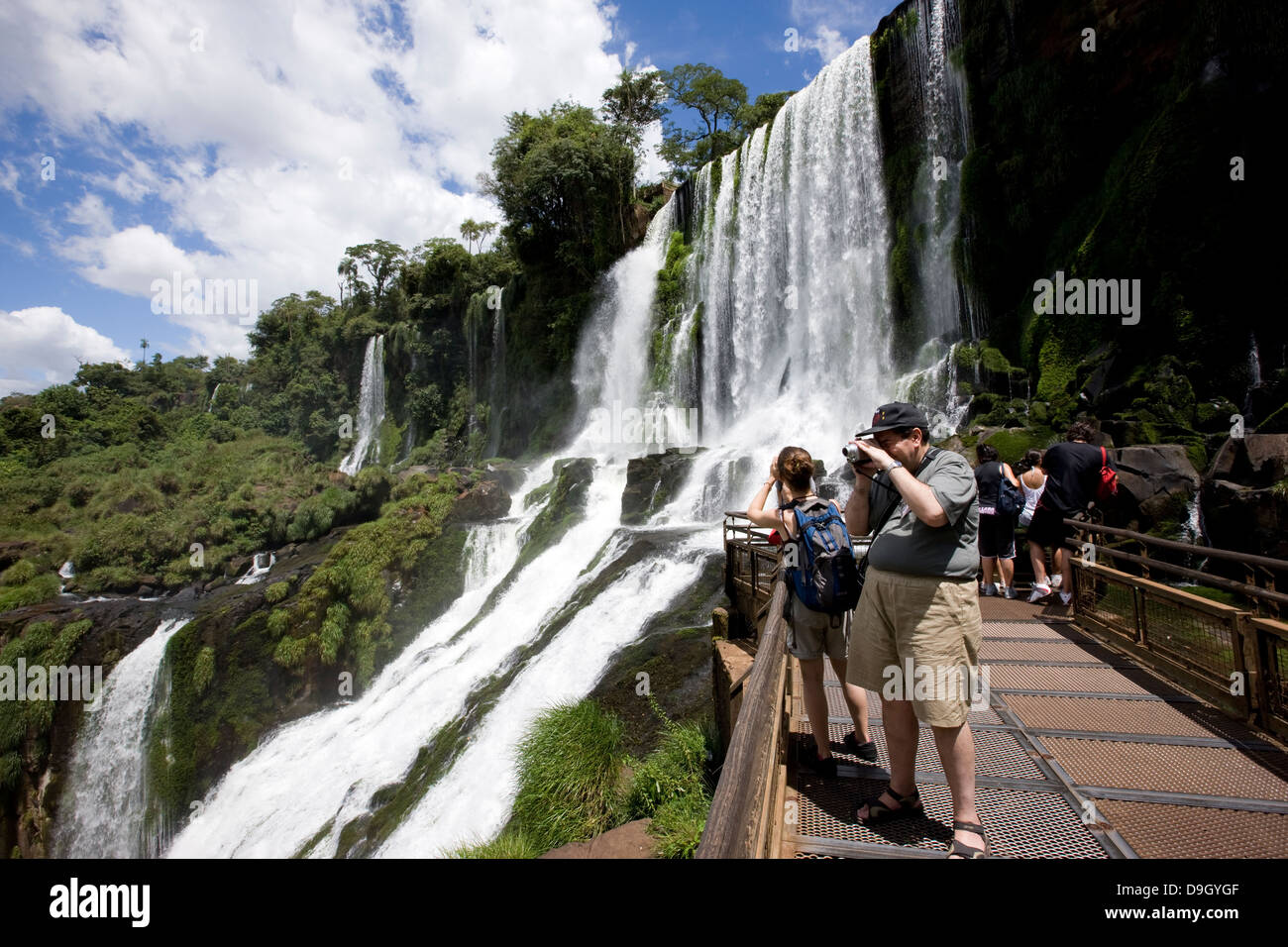Iguazu-Wasserfälle. Einige Touristen fotografieren aus die Wege eines der Routen. Stockfoto