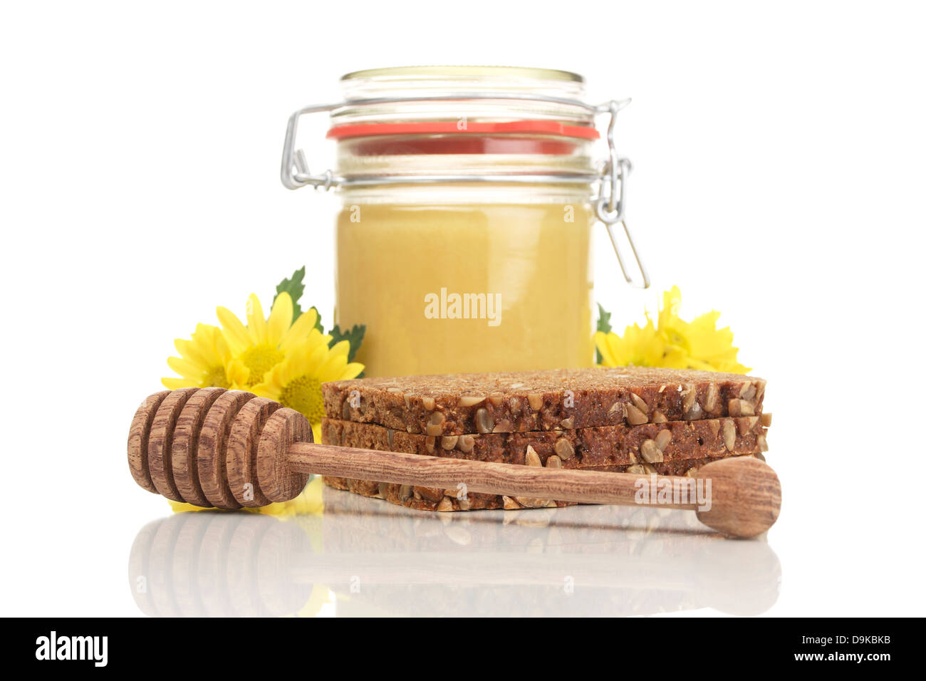 Honig-Glas mit Vollkornbrot und Löffel Honig, Honig-Glas mit Vollkornbrot und Honig-Löffel Stockfoto